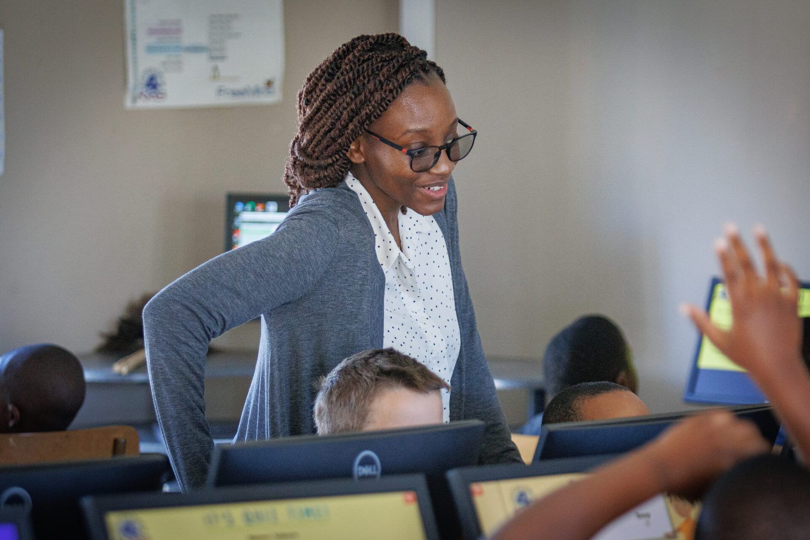Teacher guiding primary pupils